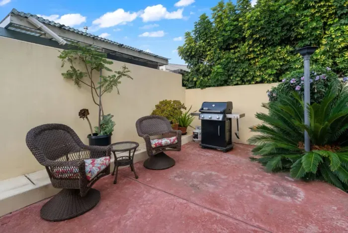 Patio with BBQ grill for outdoor cooking.