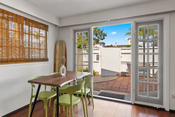 Dining nook opening onto sunny outdoor