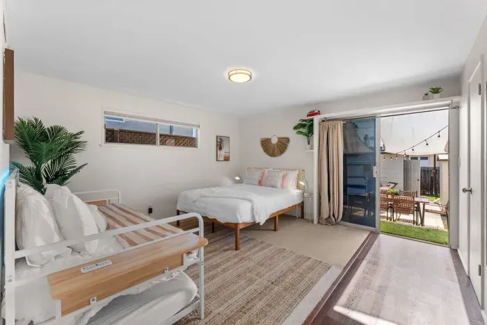 Bedroom opens to patio with sunlight streaming in