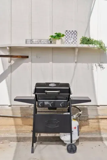 Backyard grill under the “Locals Only” sign