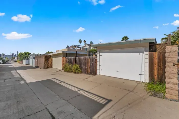 Sunlit driveway leading to private garage access