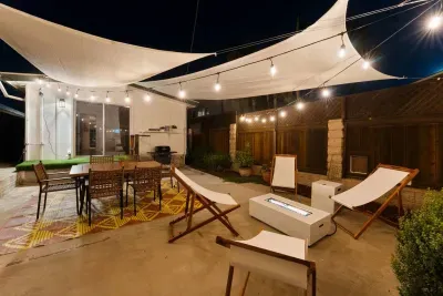 Lantern-lit patio with fire pit and sail shades