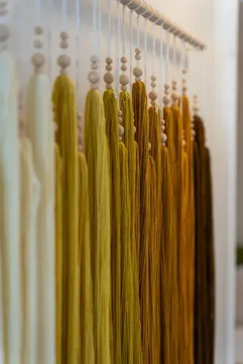 Beaded curtain glows in amber and cream light