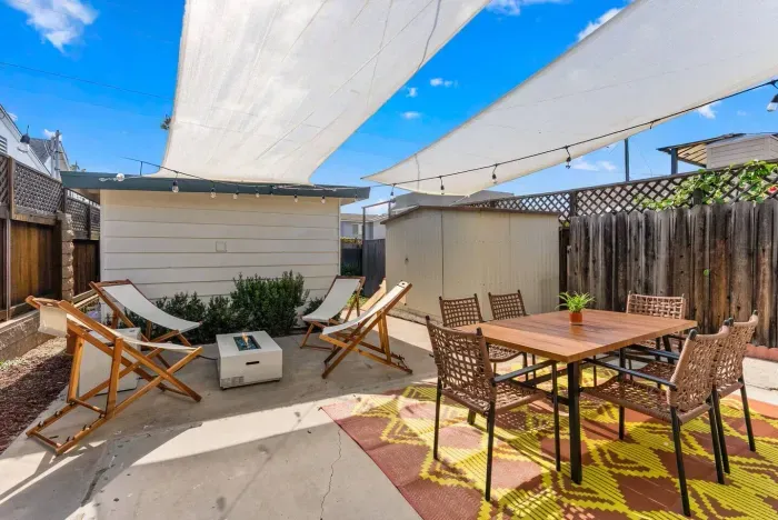 Golden hour patio with lounge chairs and dining table