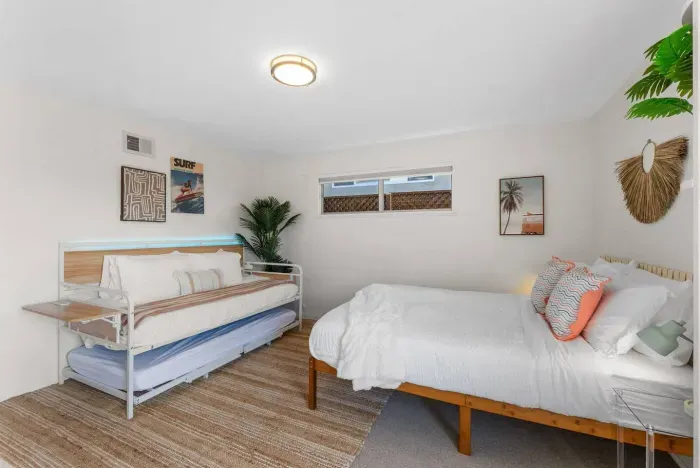 Twin beds and palm decor meet mid-century charm