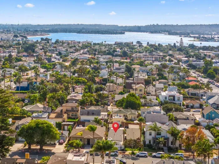 Aerial view of seaside rooftops and palm-lined streets