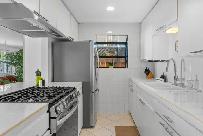 Bright galley kitchen with stainless steel accents