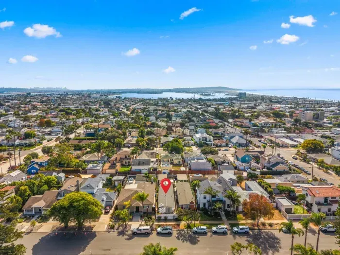 Surf-side homes glinting under afternoon sun