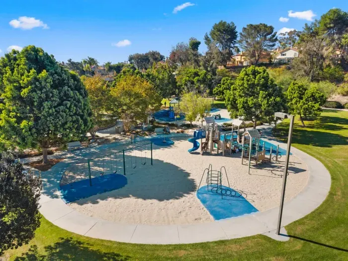 Neighborhood park with slides shaded by mature trees