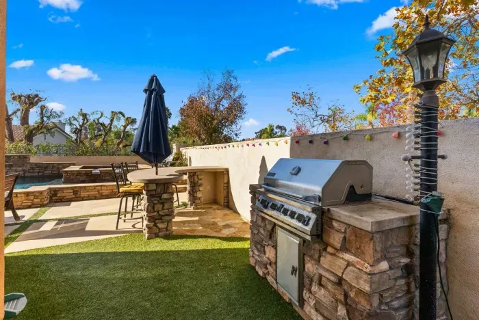 Stone grill and bar ready for sunny backyard cookouts