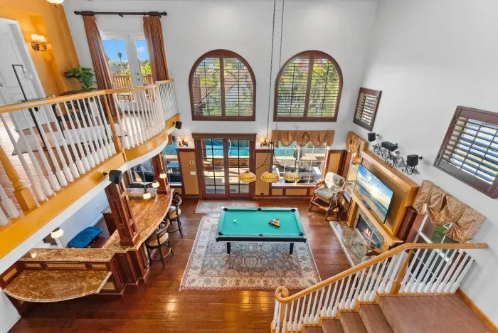 Loft view over arched windows and pool table below