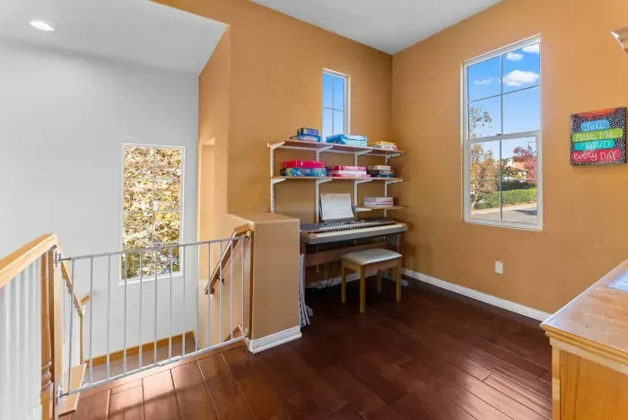 Reading nook with piano tucked beside the stairwell window
