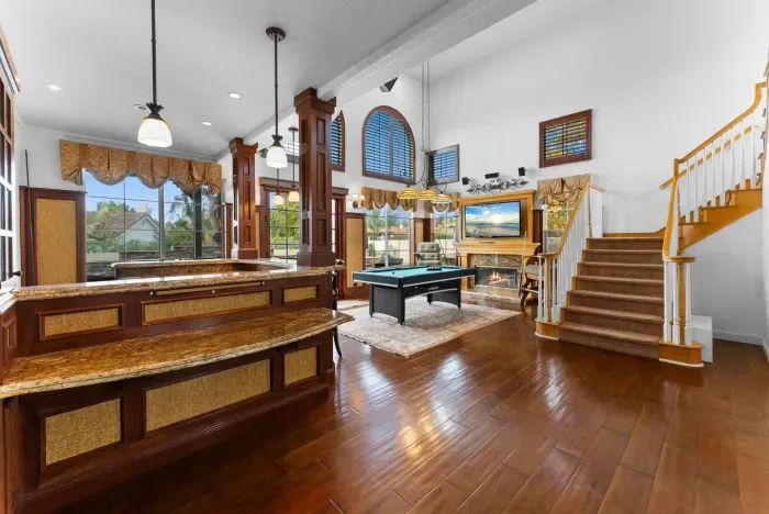 Sunlight streams into an open-plan living and game area