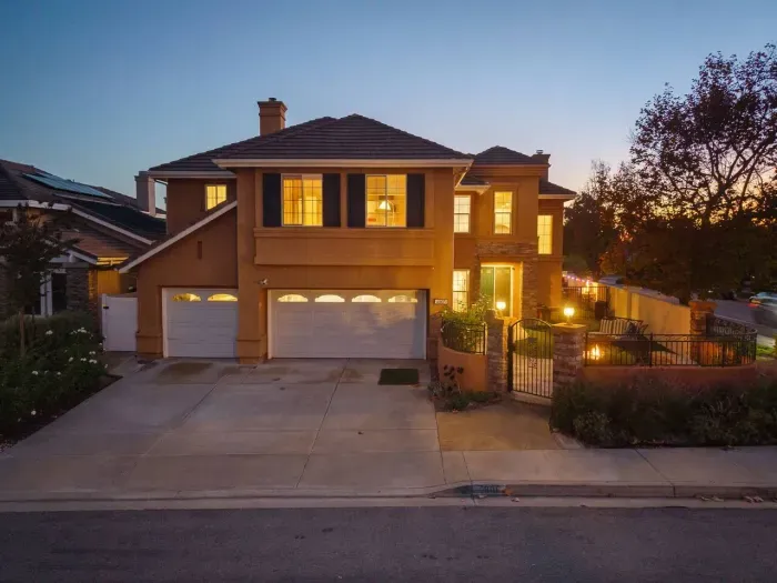 Entryway glows softly as dusk settles on quiet street