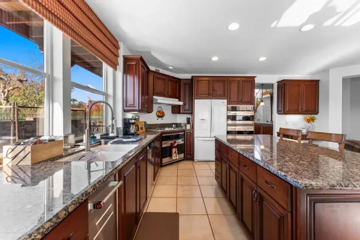 Wide kitchen views stretch to the garden through arched windows