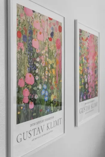 Close-up of Klimt prints in soft blush and gold hues