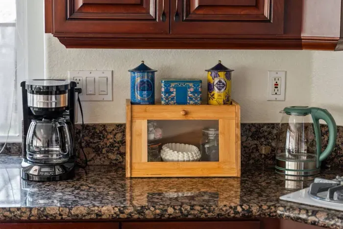 Coffee nook with wood breadbox and bright ceramic jars
