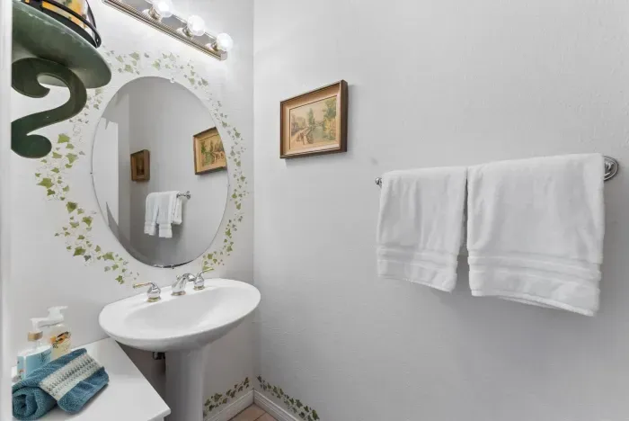 Room accented by floral mirror and framed art