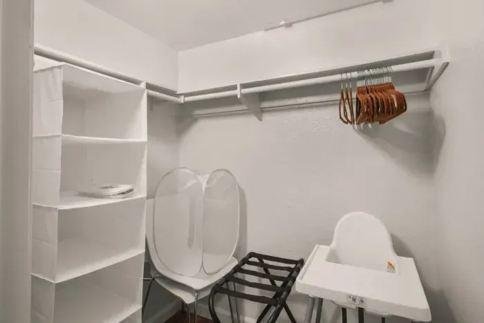 The closet of bedroom 2 where we store conveniences such as a luggage rack and high chair for little ones