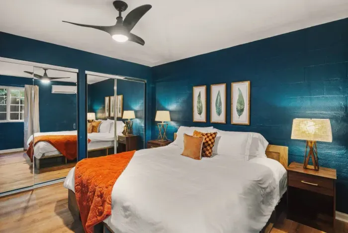 Bedroom 1 features a comfy bed, large closets, a mini split heating and cooling system, as well as light blocking curtains