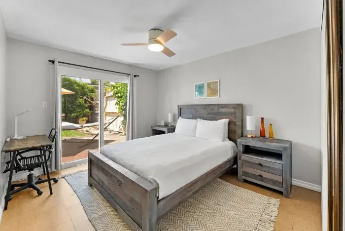 Bright and airy bedroom with a king bed, private patio access, and modern rustic touches for ultimate relaxation.