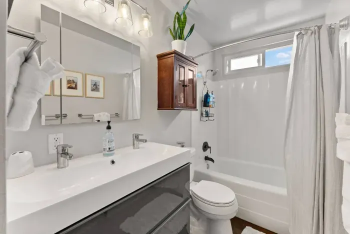 Bright and modern bathroom with double vanity, soaking tub, and stylish finishes for a refreshing retreat.