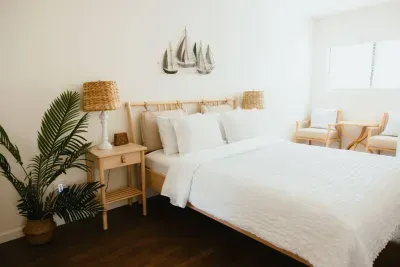 Bright bedroom with crisp white bedding and coastal décor accents.