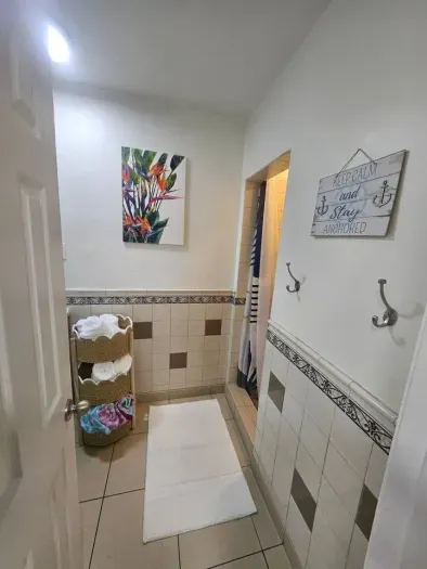 Bright bathroom with fresh towels, modern touches, and a colorful accent for a cheerful stay.