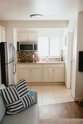 Compact kitchen with light cabinets and plenty of natural light.