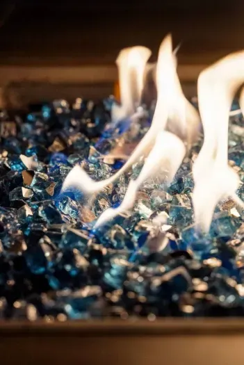 Cozy fire pit with mesmerizing blue glass—perfect for relaxing nights!