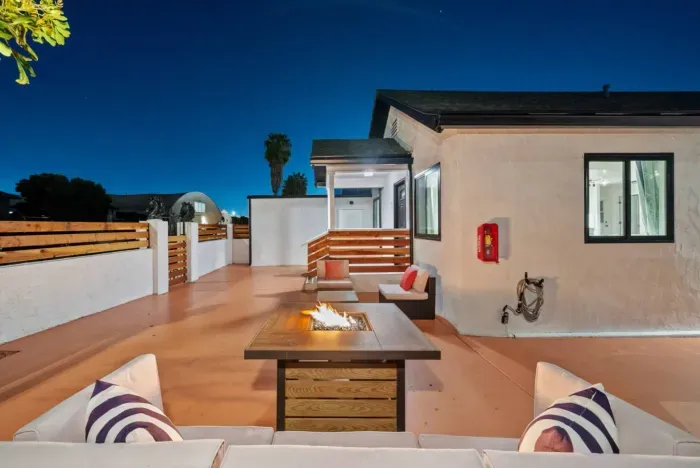 Relax in a stylish outdoor lounge with a cozy fire pit under the stars!