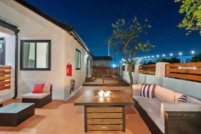 Relax in this stylish outdoor oasis with a cozy fire pit!