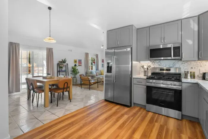 Bright open-concept kitchen, dining, and living space with modern finishes.