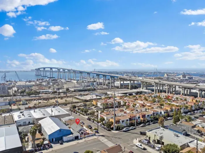 Daytime view of Coronado Bridge, shipyards, and a highlighted property.
