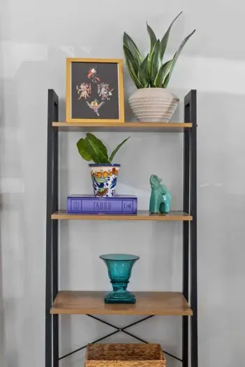 A beautifully curated shelf adding character and charm to the space!