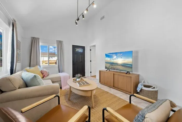 A bright and stylish living space with cozy textures, natural tones, and modern accents.