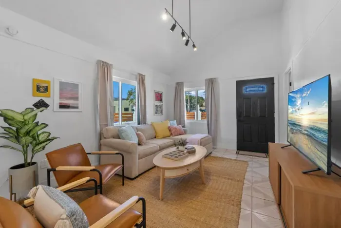 A cozy and modern living room with warm tones, stylish decor, and natural light.