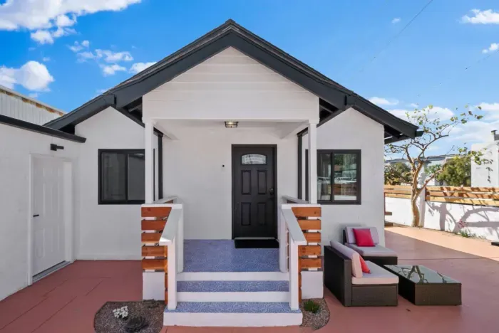 Charming front entrance with a cozy outdoor seating area.