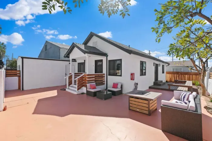 Spacious backyard with stylish seating and a cozy fire pit for relaxing nights.