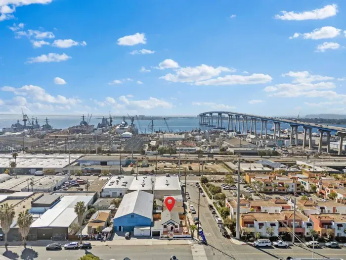 Skyline view of Coronado Bridge, shipyards, and a marked property.