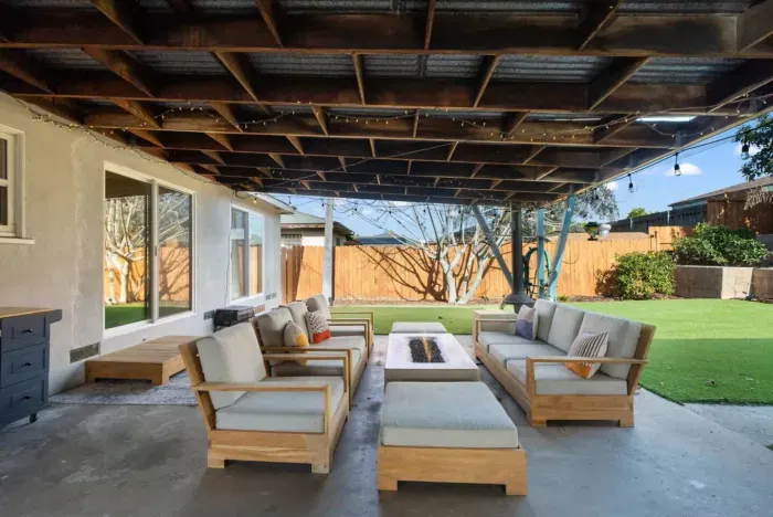 Unwind in this stylish outdoor lounge with a cozy fire pit!