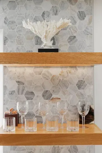 A cozy and stylish bedroom featuring soft neutral tones, elegant decor, and warm ambient lighting.