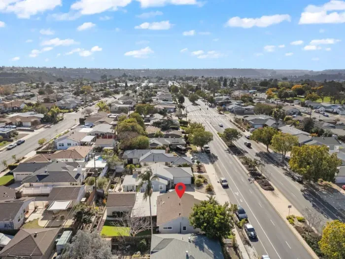 Aerial view of a marked house in a suburban neighborhood.