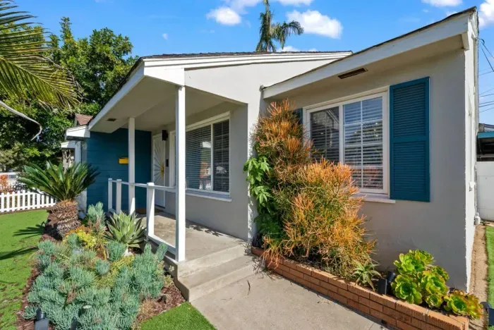 Cozy front porch with lush greenery—welcome home!