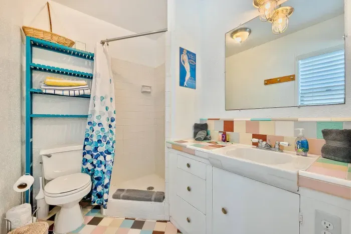 Freshen up in a clean, beachy bathroom after a day in the surf.