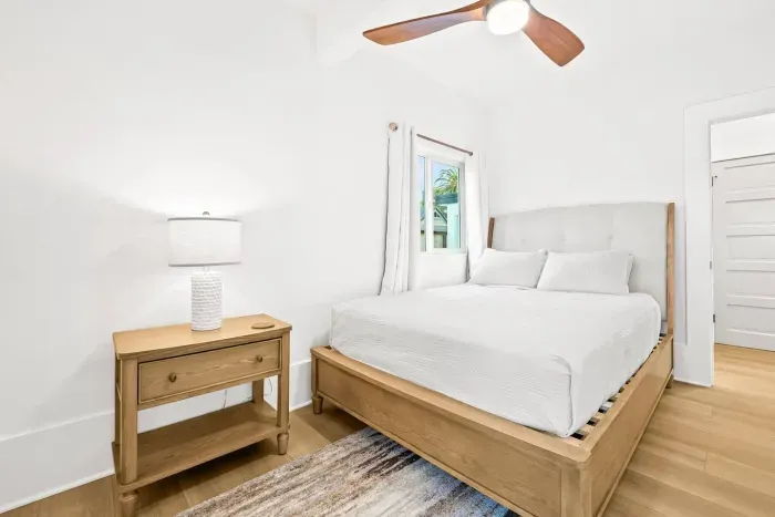 Peaceful bedroom with soft bedding and natural light.