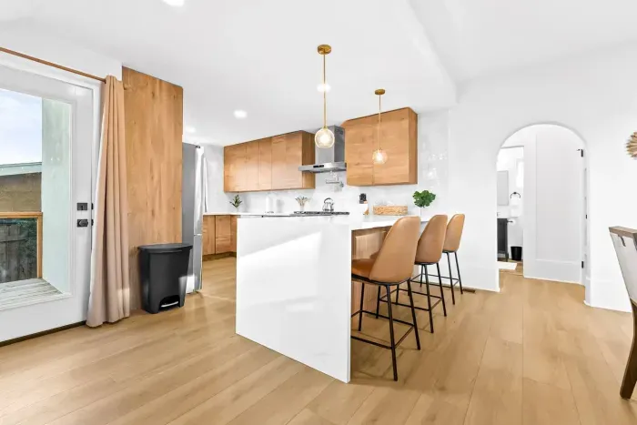 Bright kitchen with island seating and warm wood cabinets.