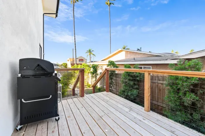 Backyard deck with BBQ grill and sunny outdoor space.