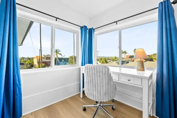 Corner desk area with sunlight and views.