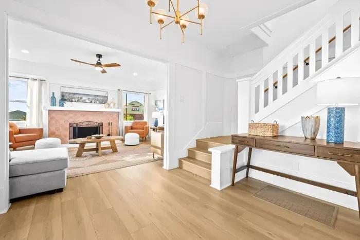 Living room by the stairs with bright, open layout.
